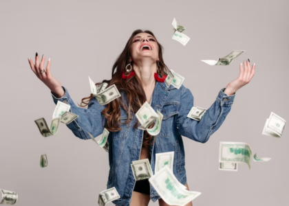 Woman in Denim Jacket Smiling with Money Everywhere
