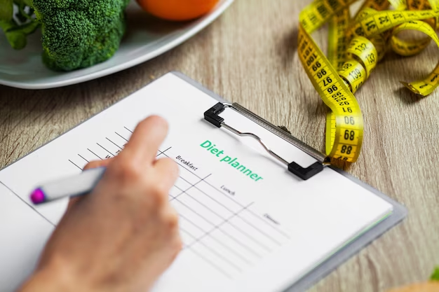 Handwritten diet planner with vegetables and measuring tape